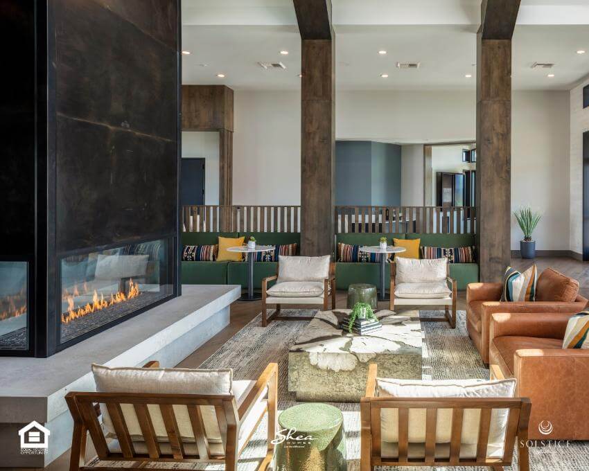 Modern lounge area with fireplace and cozy seating.