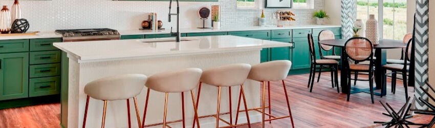 Modern kitchen with island, seating, and dining area.