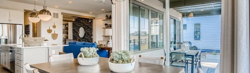Modern kitchen and dining area with large windows.
