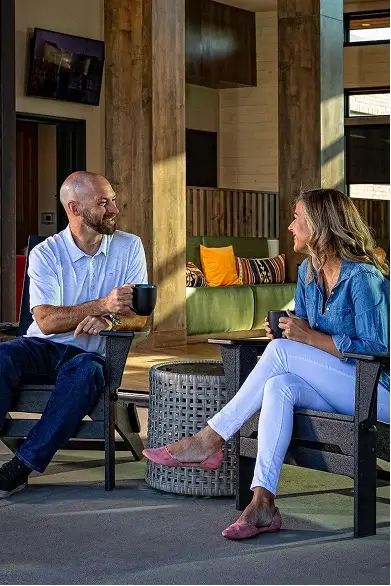 Couple sitting and talking on modern outdoor patio