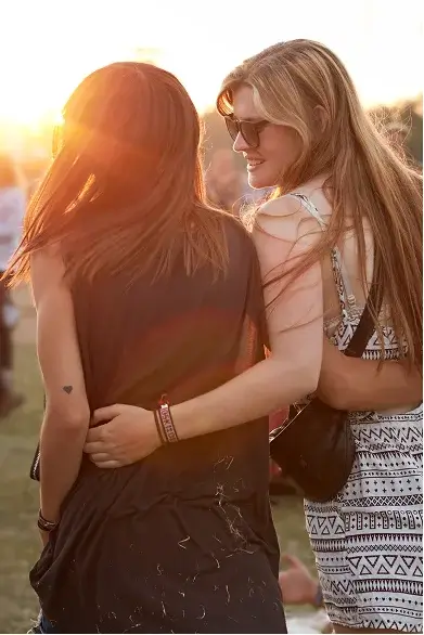 Two friends embracing outdoors during sunset