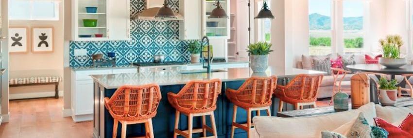 Modern kitchen with wicker chairs and mountain view.