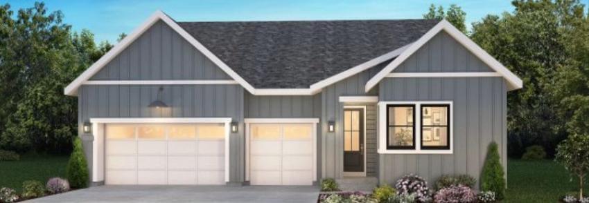 Modern grey house with two-car garage and manicured garden.