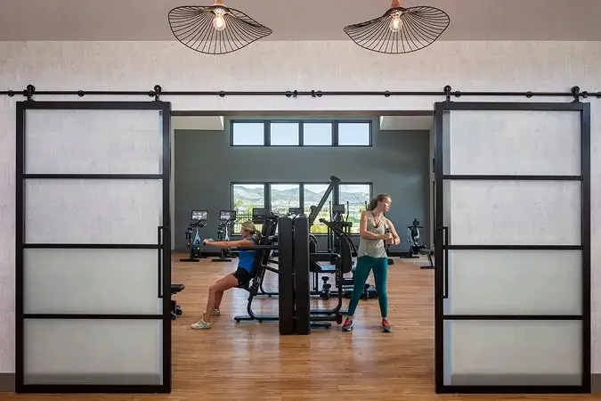 Residents working out in the modern fitness studio at Solstice community clubhouse