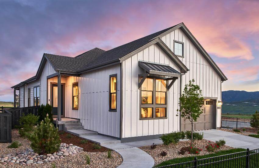 Modern house at sunset with landscaped yard.