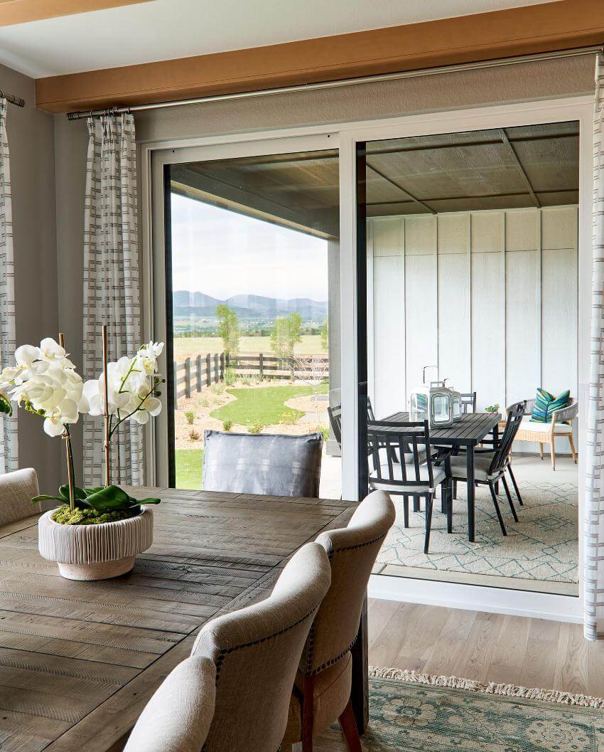 Dining table overlooking patio with mountains in background.