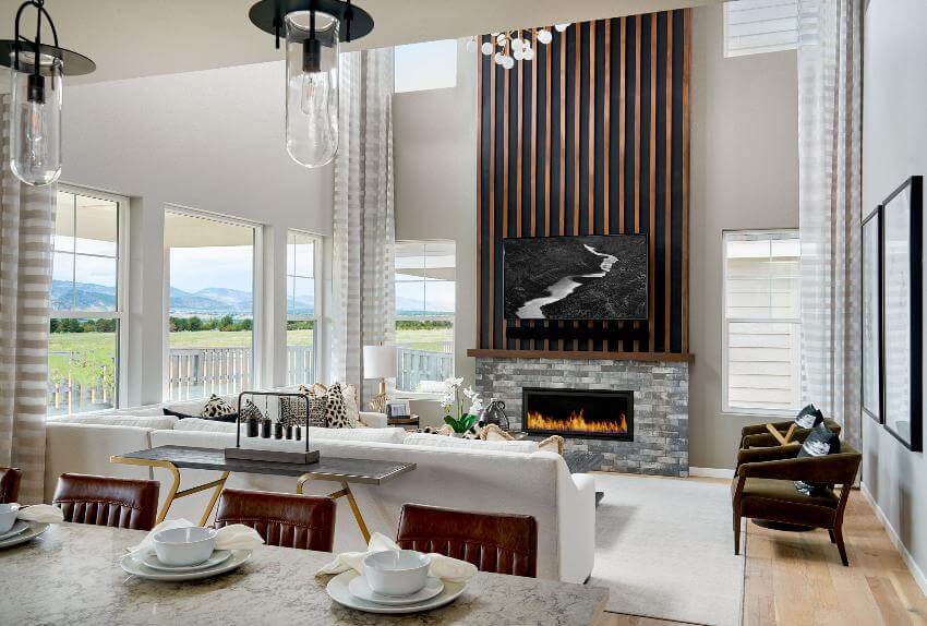 Modern living room with fireplace and large windows.