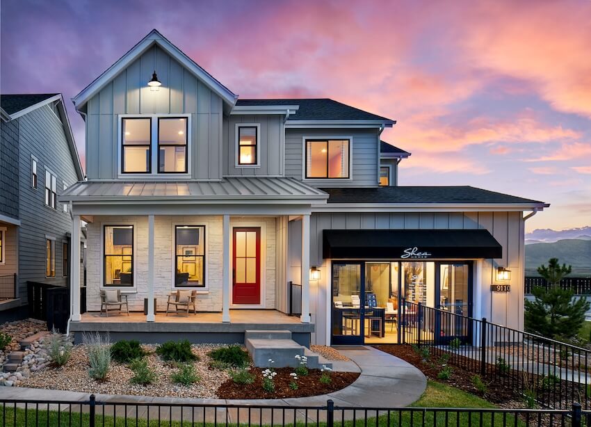 Two-story house at sunset with inviting porch.