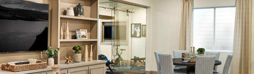Dining area with table, chairs, and decorative shelves.