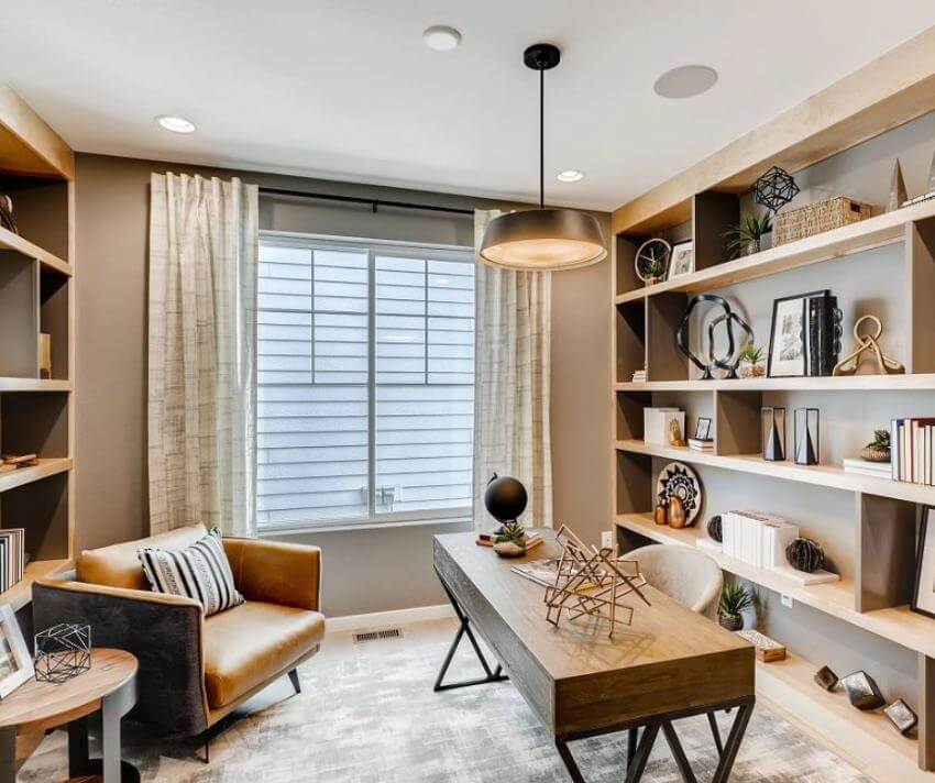 Modern home office with shelves and window view.