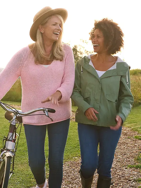 Friends enjoying a walk and bike ride along scenic community trails