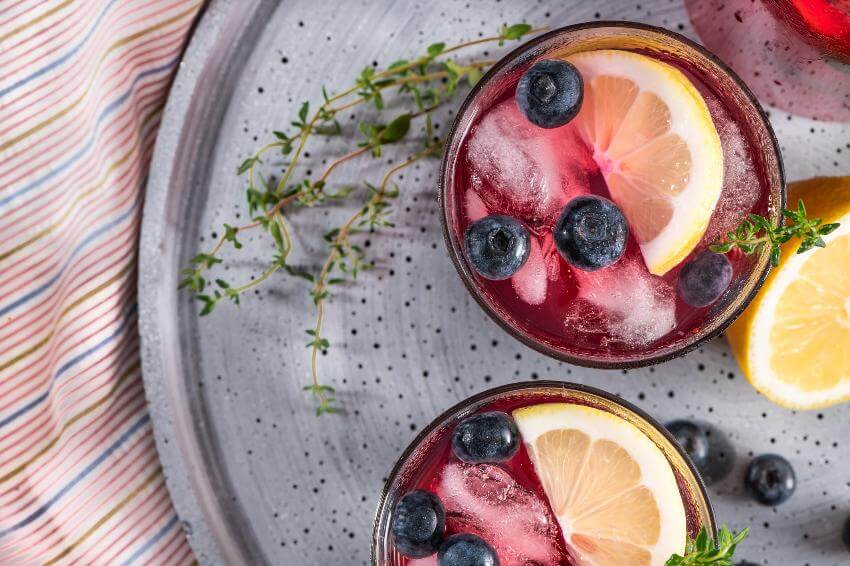 Refreshing berry lemonade with lemon slices and ice.