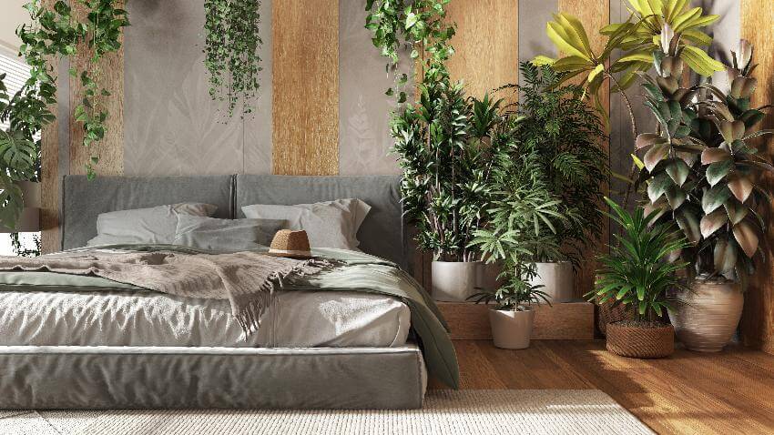 Bedroom with plants, neutral bedding, and cozy atmosphere.