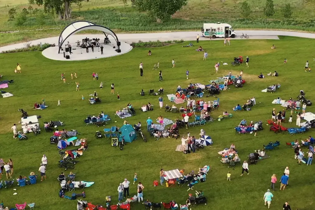 Community gathering on lawn with live band playing.